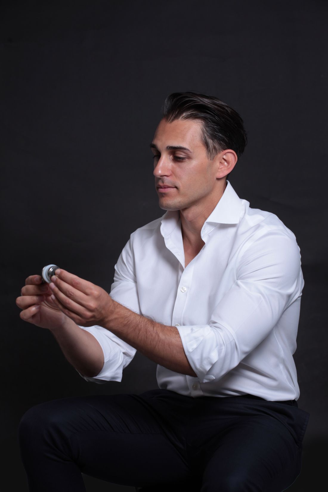 Dr Harry Constantin holding a shoulder replacement implant